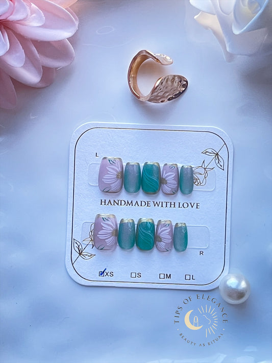 Petite floral press-on nails in green and pink with hand-painted daisies.